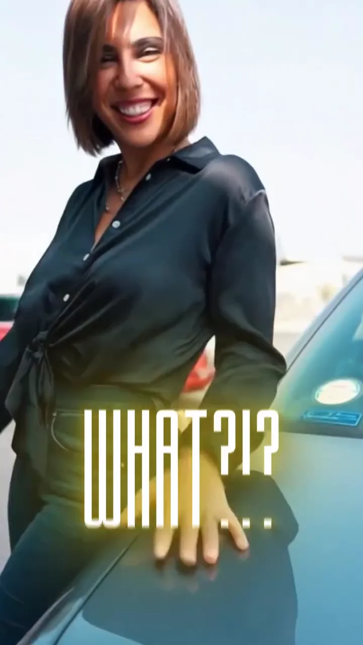 A presenter beside a blue sports car